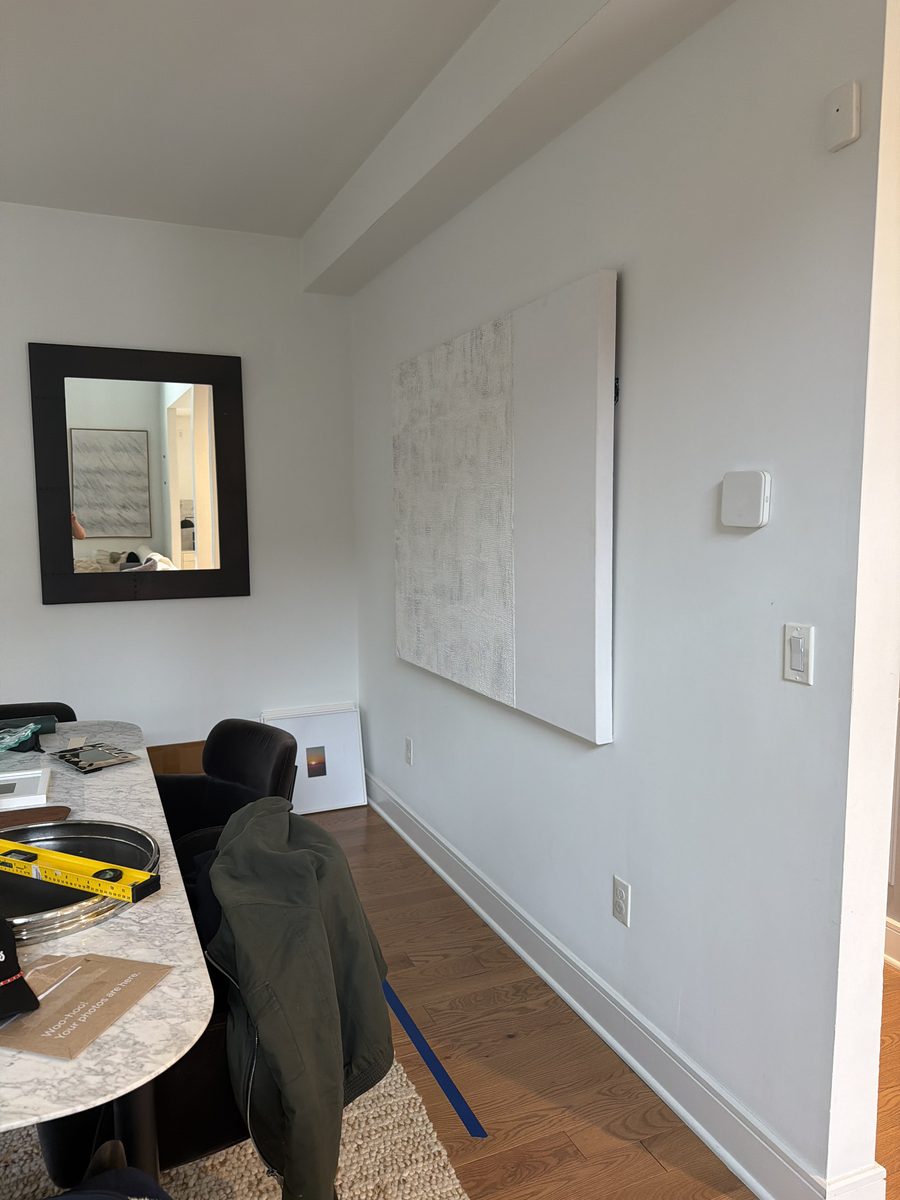 Before: bare dining room with painter's tape on the floor