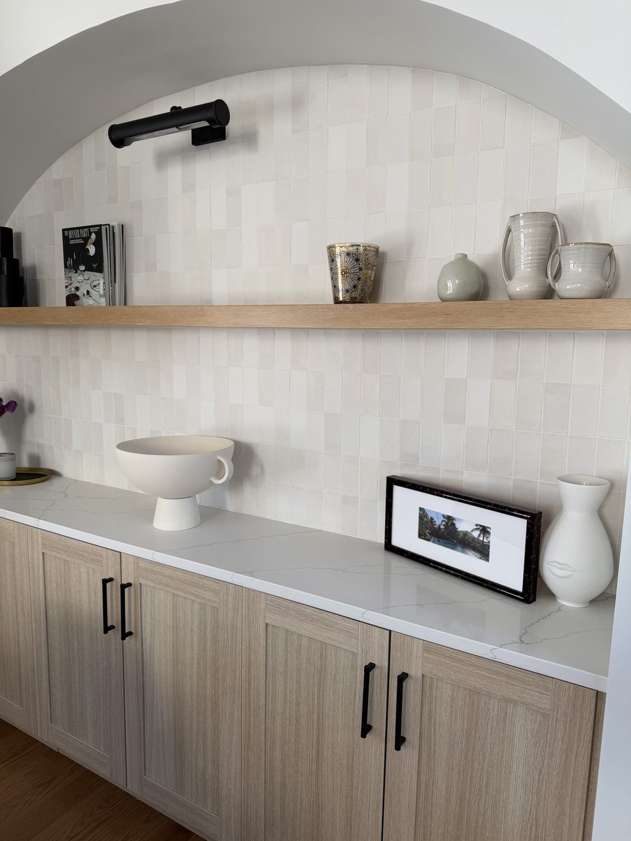 Close detail of arch, picture light, and handmade tile