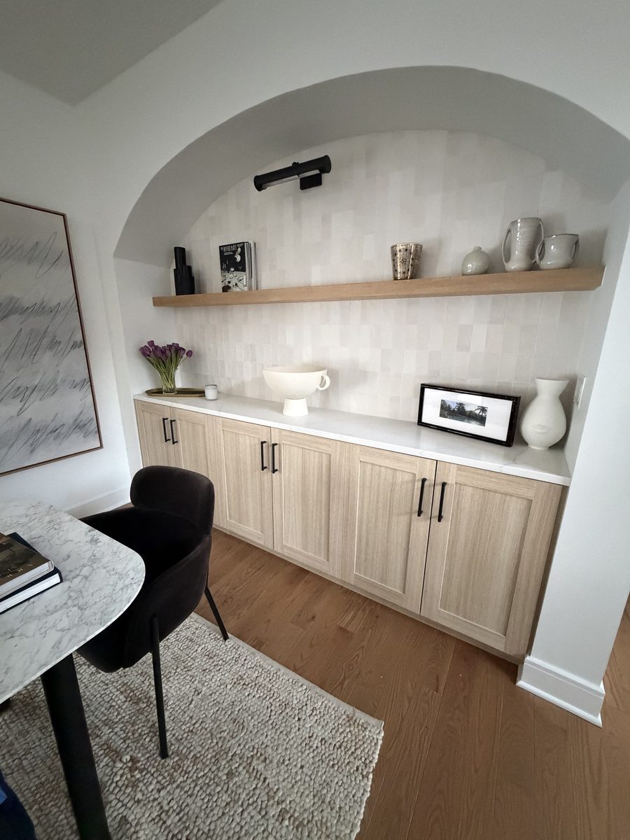 Built-in detail with floating oak shelf, zellige tile, and styled vessels