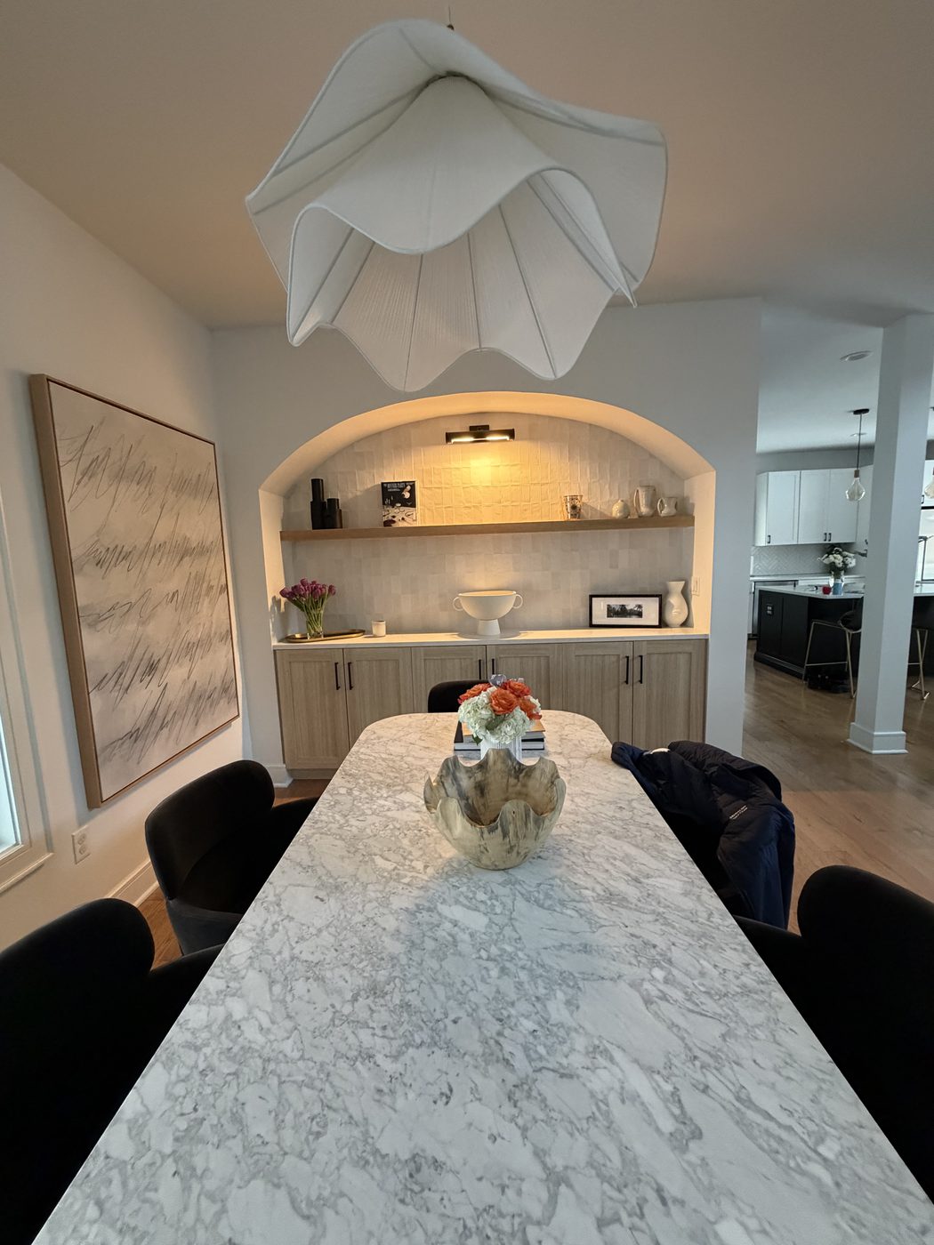 After: finished arched built-in, pendant, marble table, complete dining room